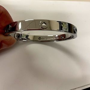 Kate Spade “spot the spade” silver studded hinged bangle.